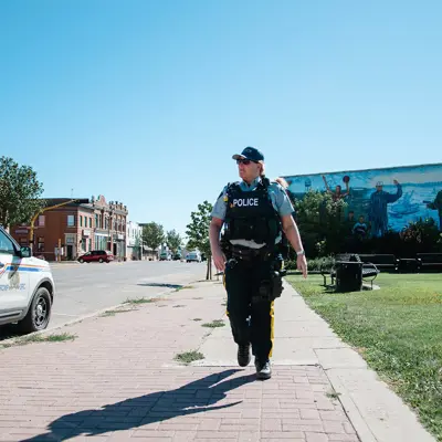 police walking down sidewalk