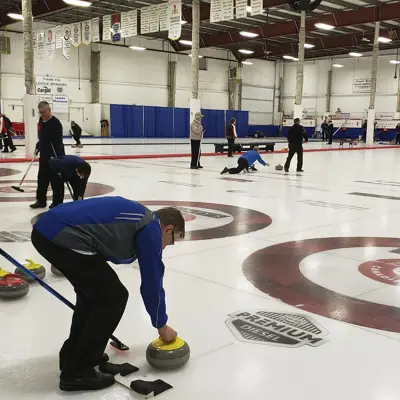people curling on indoor ice