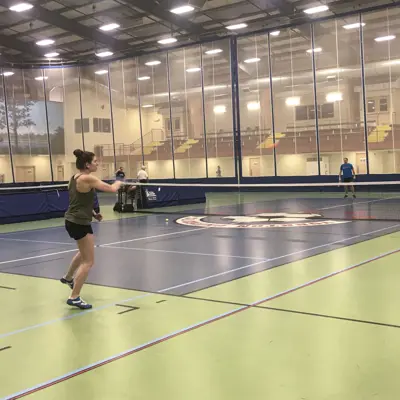 People playing indoor tennis.