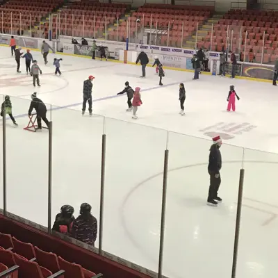 People skating on ice indoors